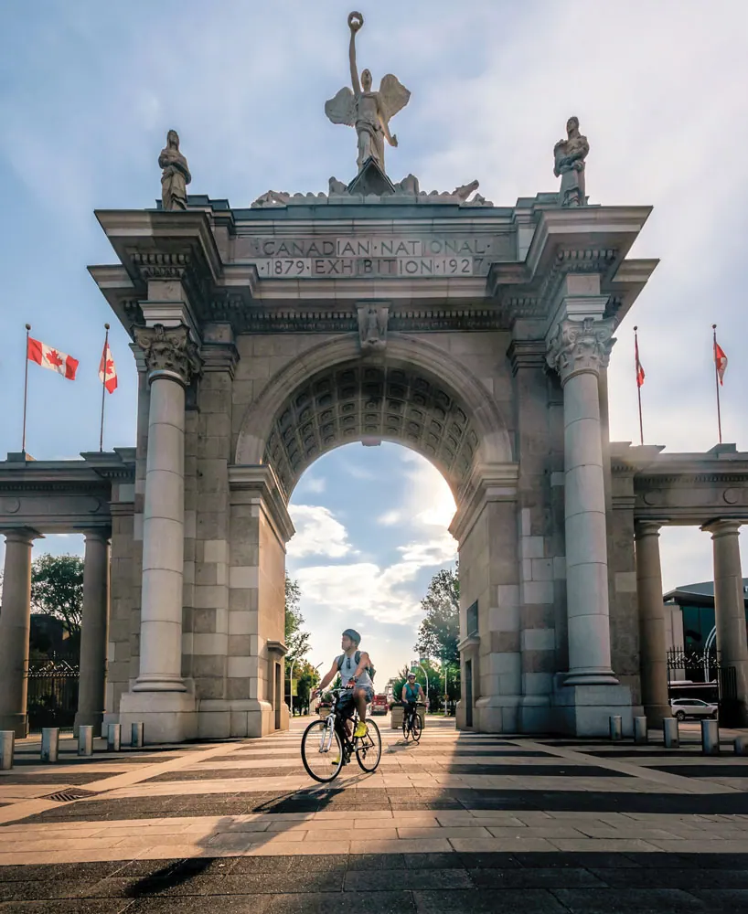A cyclist passing through the Princes' Gates at Exhibition Place