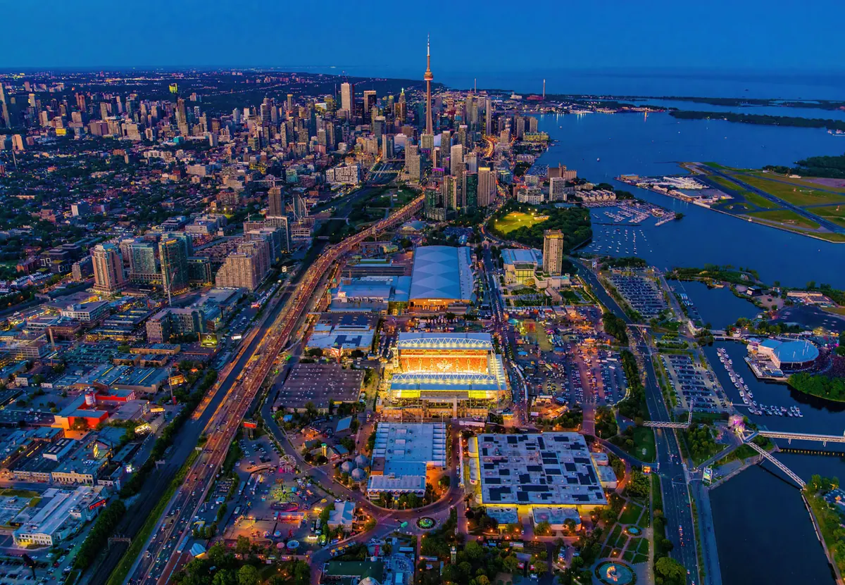 Aerial view of downtown Toronto at dusk with the CN Tower and Exhibition Place